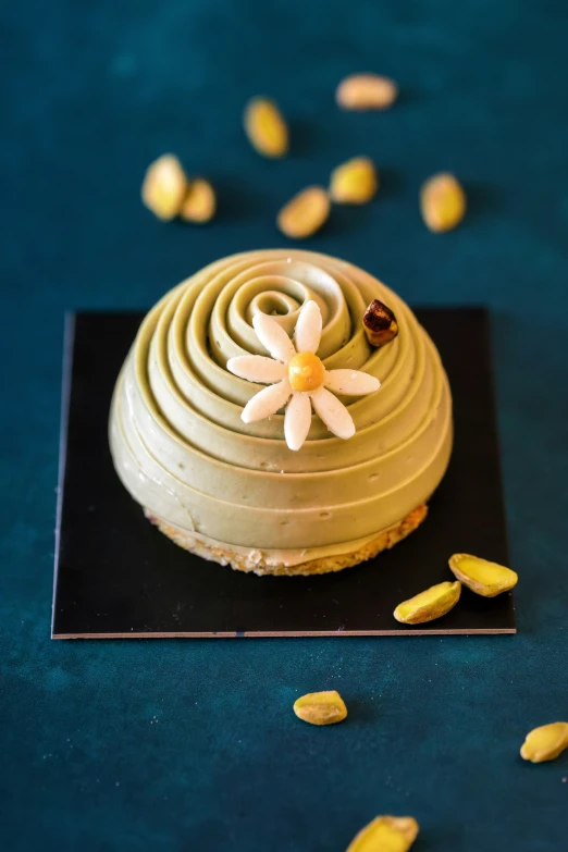 a dessert covered in a flower sits on a blue surface