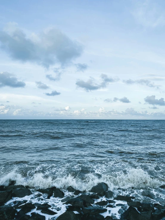 an ocean shore is shown with rough waves