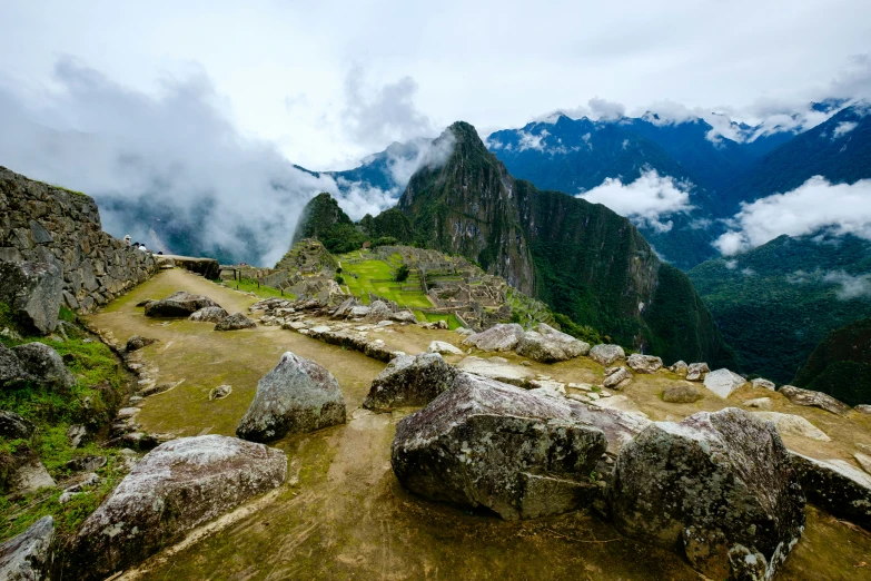 a group of large rocks with a mountain in the background