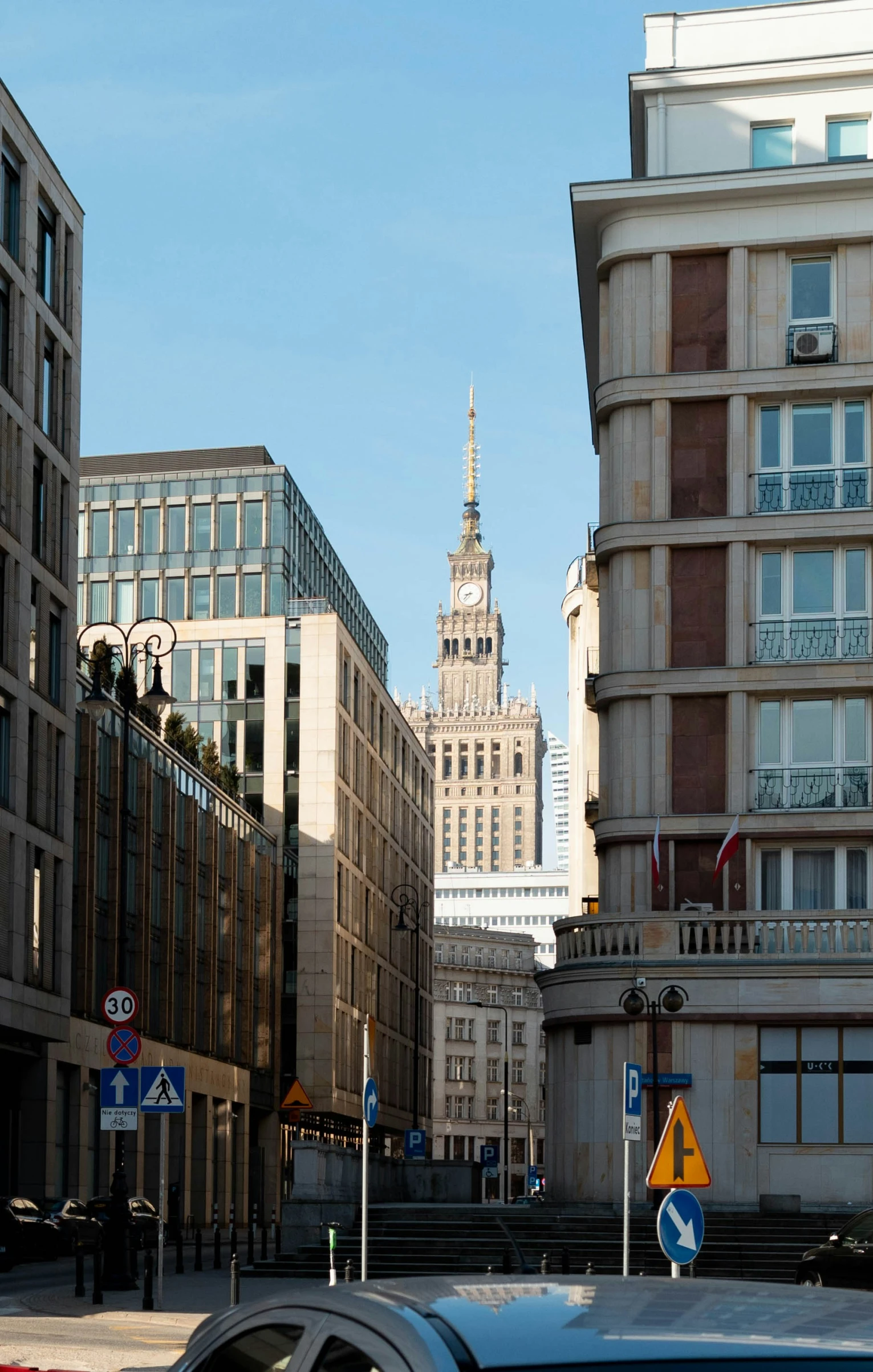 cars and traffic on a city street with buildings in the background