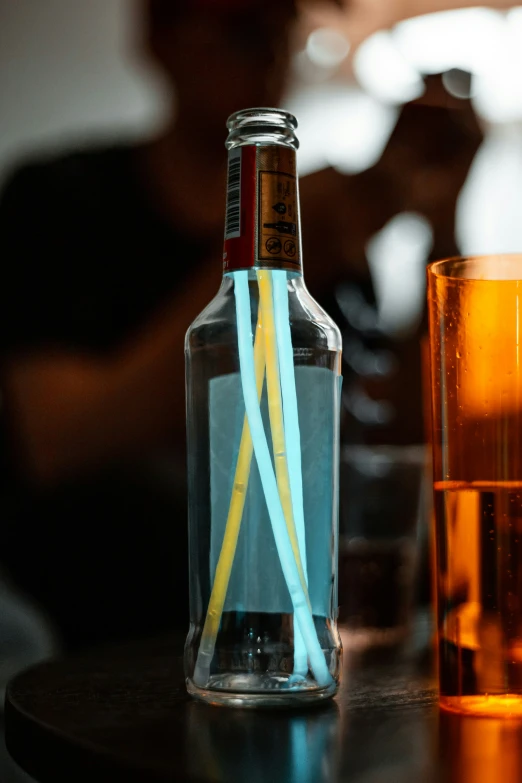 a bottle of liquor and some glassware on a table