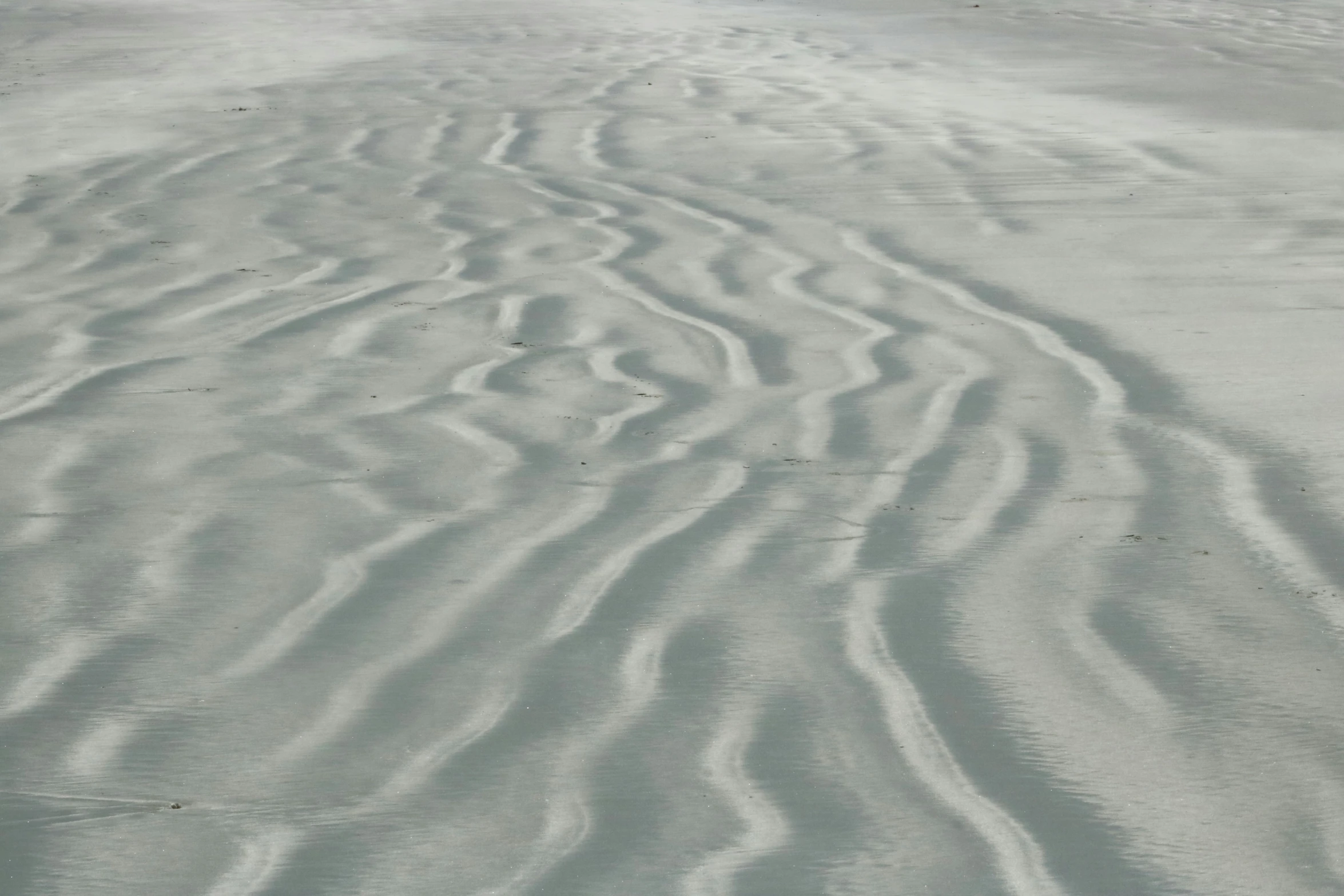 the view from the air shows wavy patterns in the sand