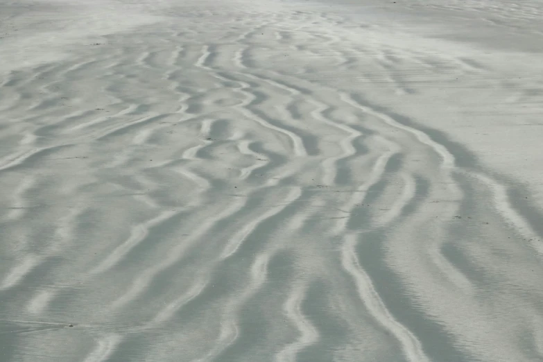 the view from the air shows wavy patterns in the sand