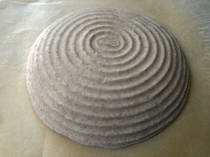 a circular object sitting on top of a brown surface