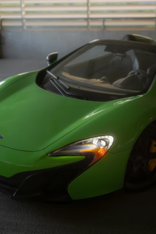 a green car is parked in front of a large building