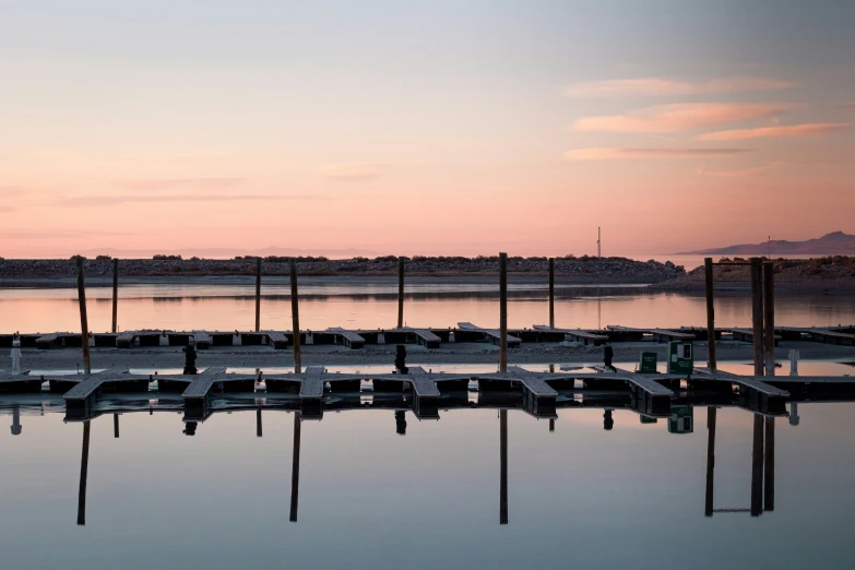 several boats are docked at the end of a dock