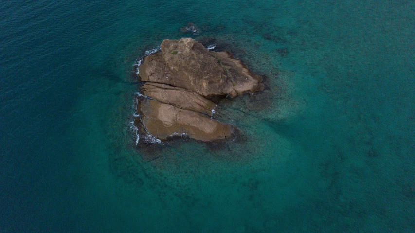 some large rocks in the middle of the water