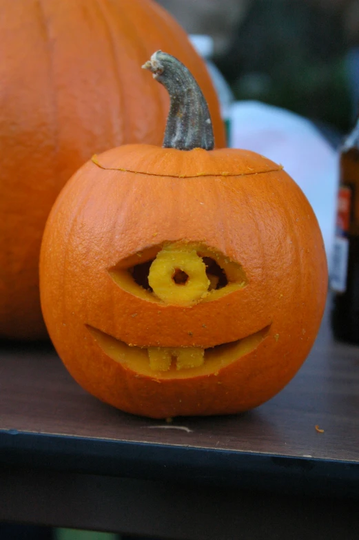 a close up of two pumpkins with a face carved into them