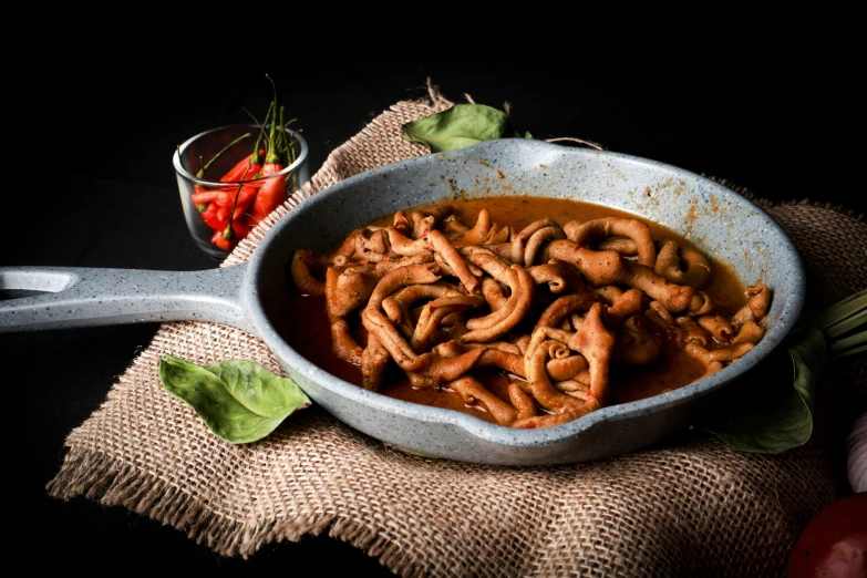 a bowl of food that is next to some carrots and a plate