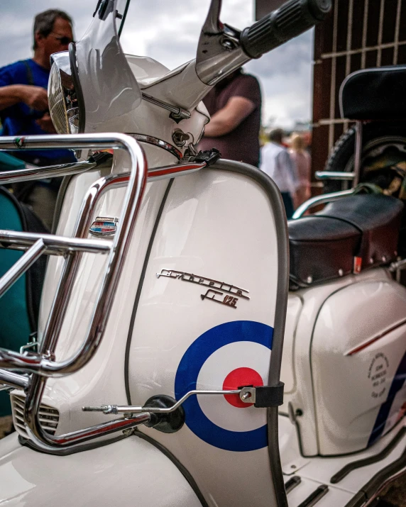 a close up of a white motorcycle with a chrome rack