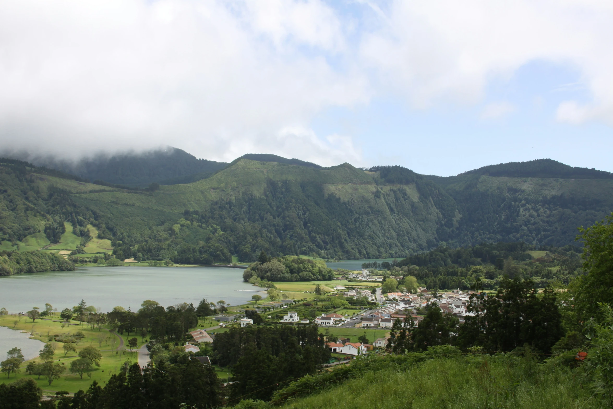 a beautiful town nestled in the mountains with lush green vegetation