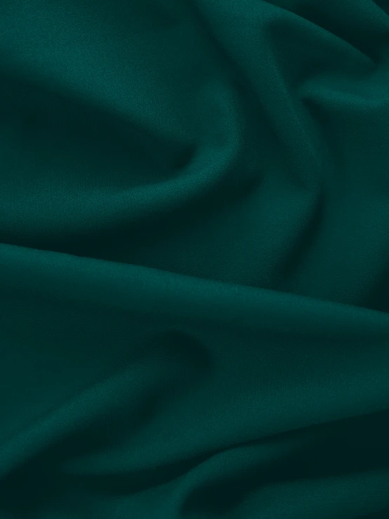 green fabric close up with dark texture