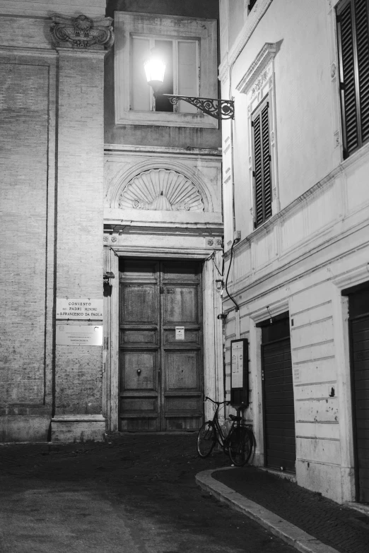 an entrance of an old city street with an umbrella in the corner