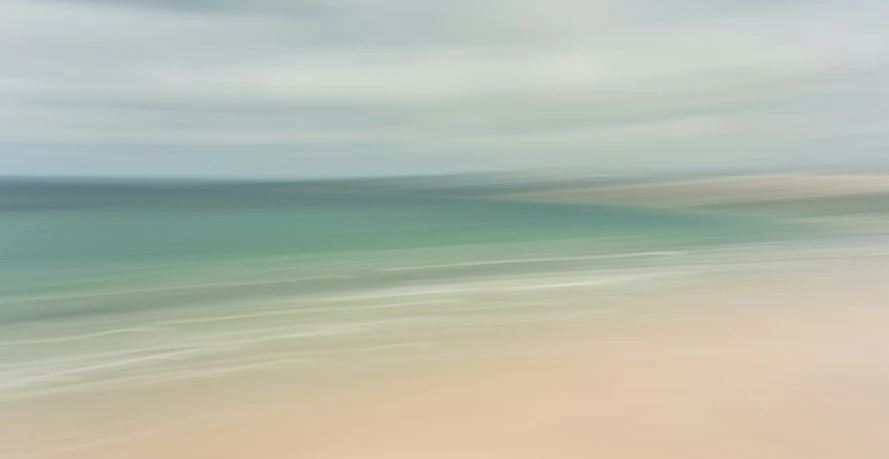 an aerial view of the ocean from the sand