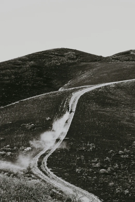 a dirt path and a mountain pass in black and white