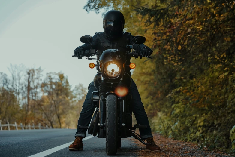 a man on a motorcycle sits by himself