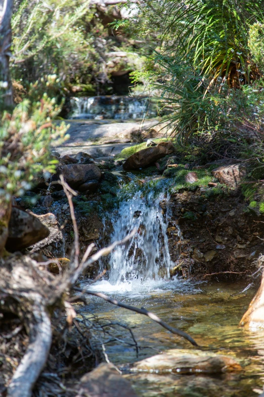 a small waterfall has several flowing water