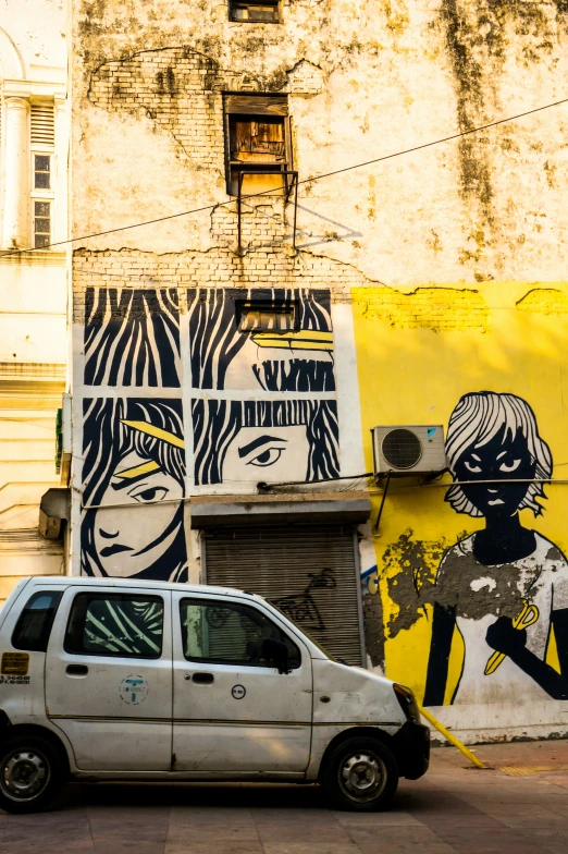 an image of an old car in front of the colorful building wall