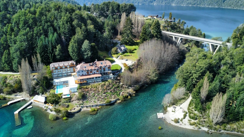 an aerial view of a large building next to a body of water