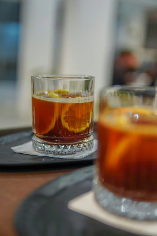 glass cup with ice and fruit drink in the foreground