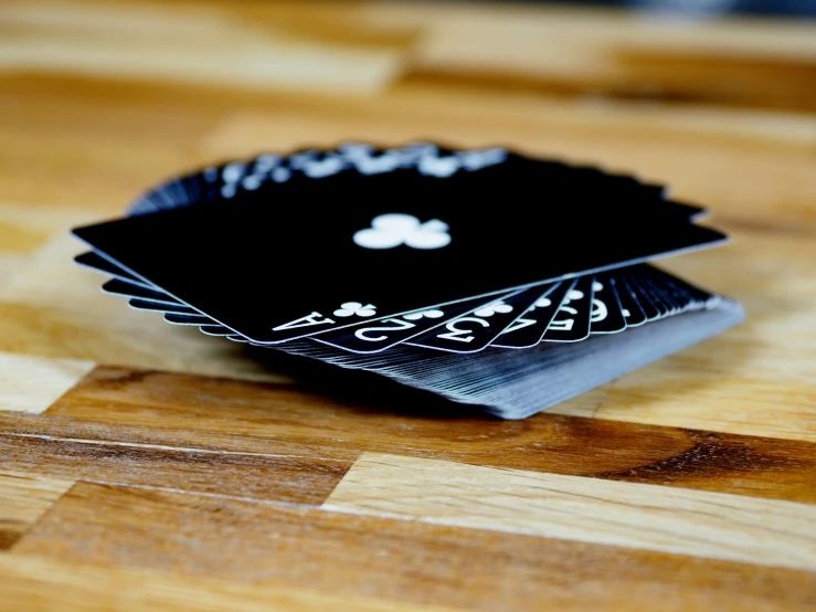 four playing cards sitting on top of each other