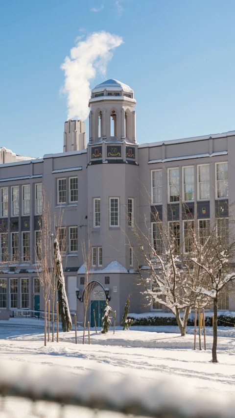 the building has many windows and is covered in snow