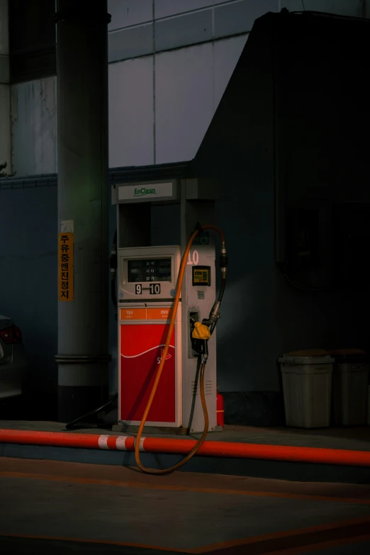 an atm standing next to a gas pump