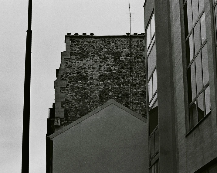 two street lamps on side of building and a sky background