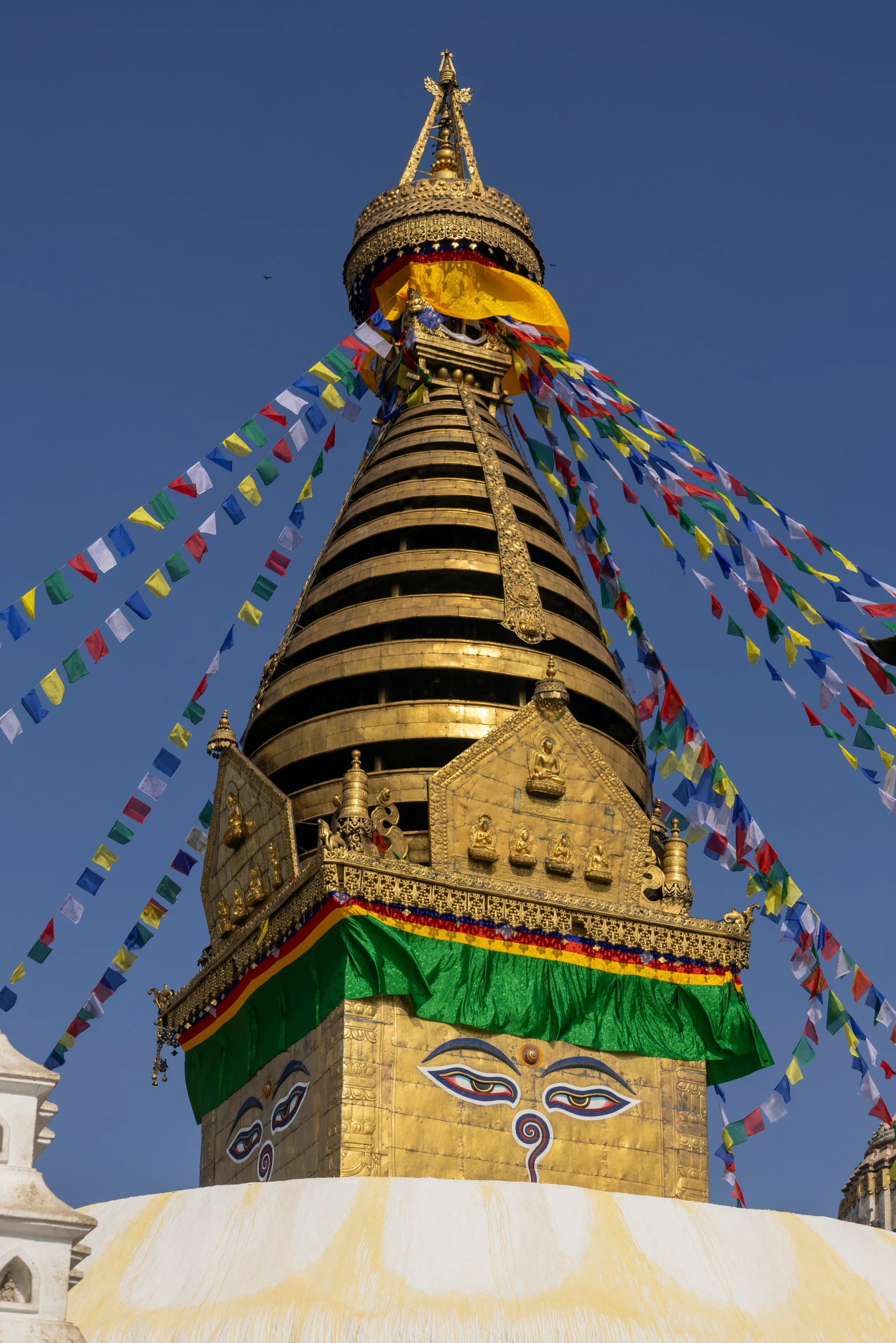 a steeple with many flags blowing from it