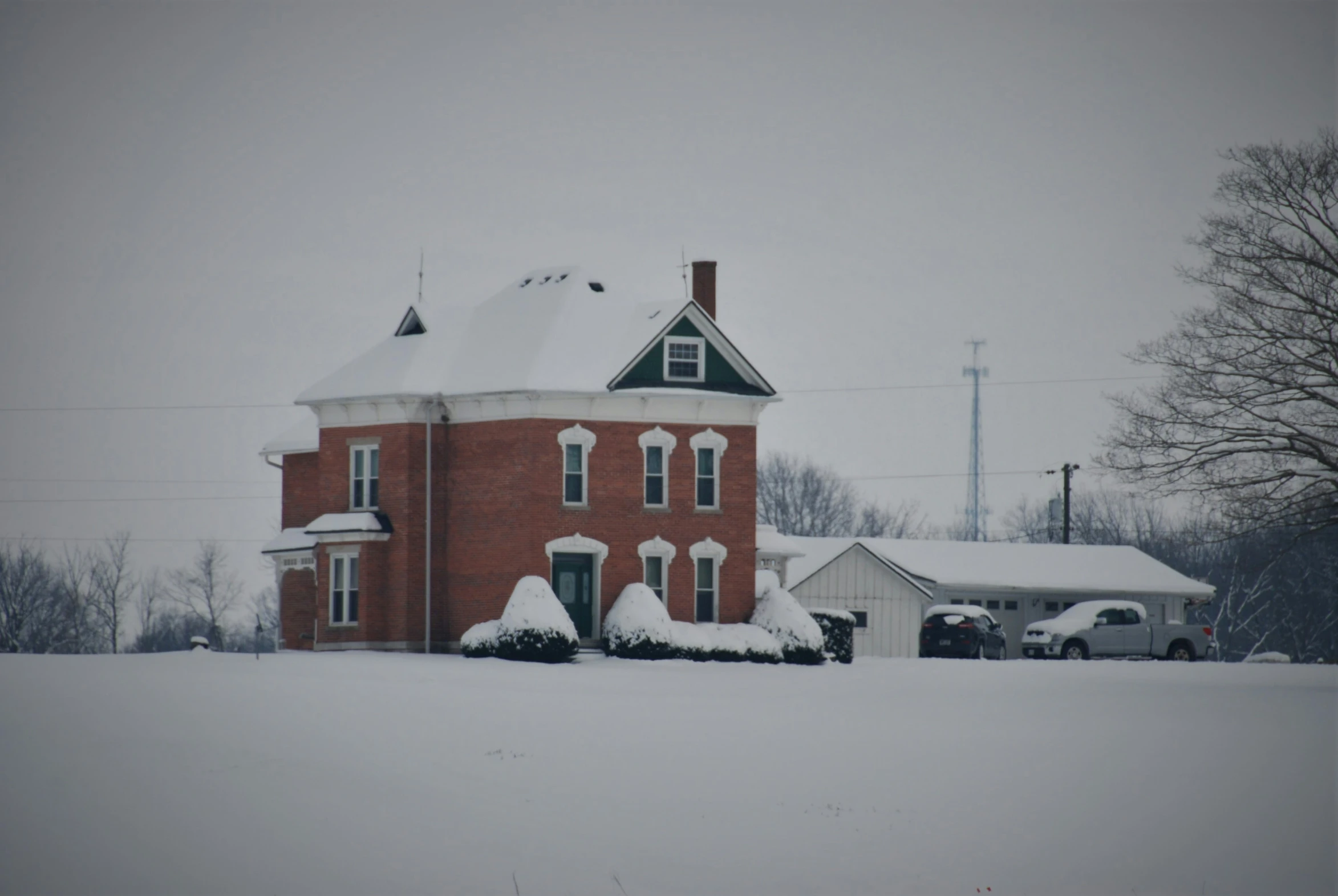 a big house with a lot of snow all around it