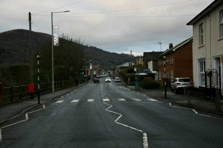 the road is empty with cars parked on it