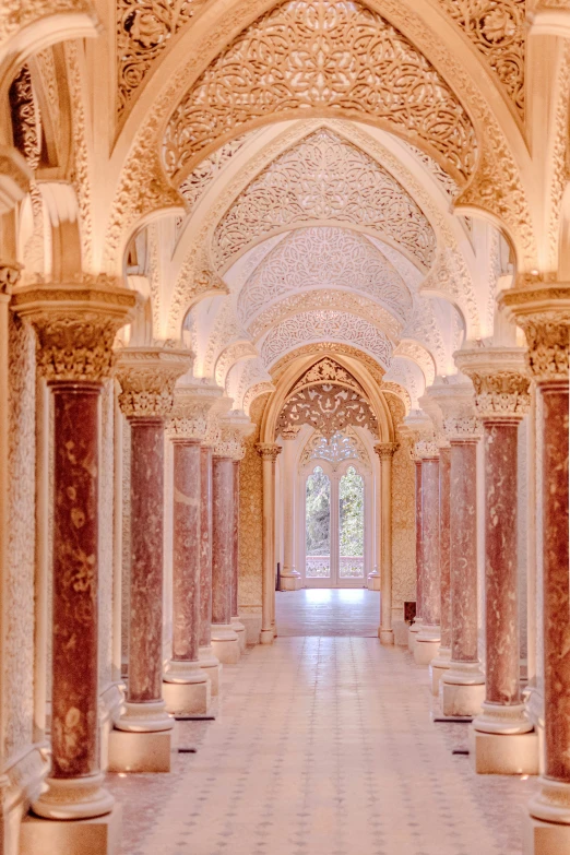 a very ornate white hall with columns and a clock