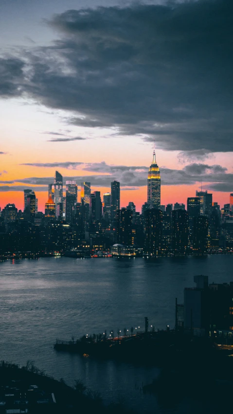 a city skyline at night lit up from across the water