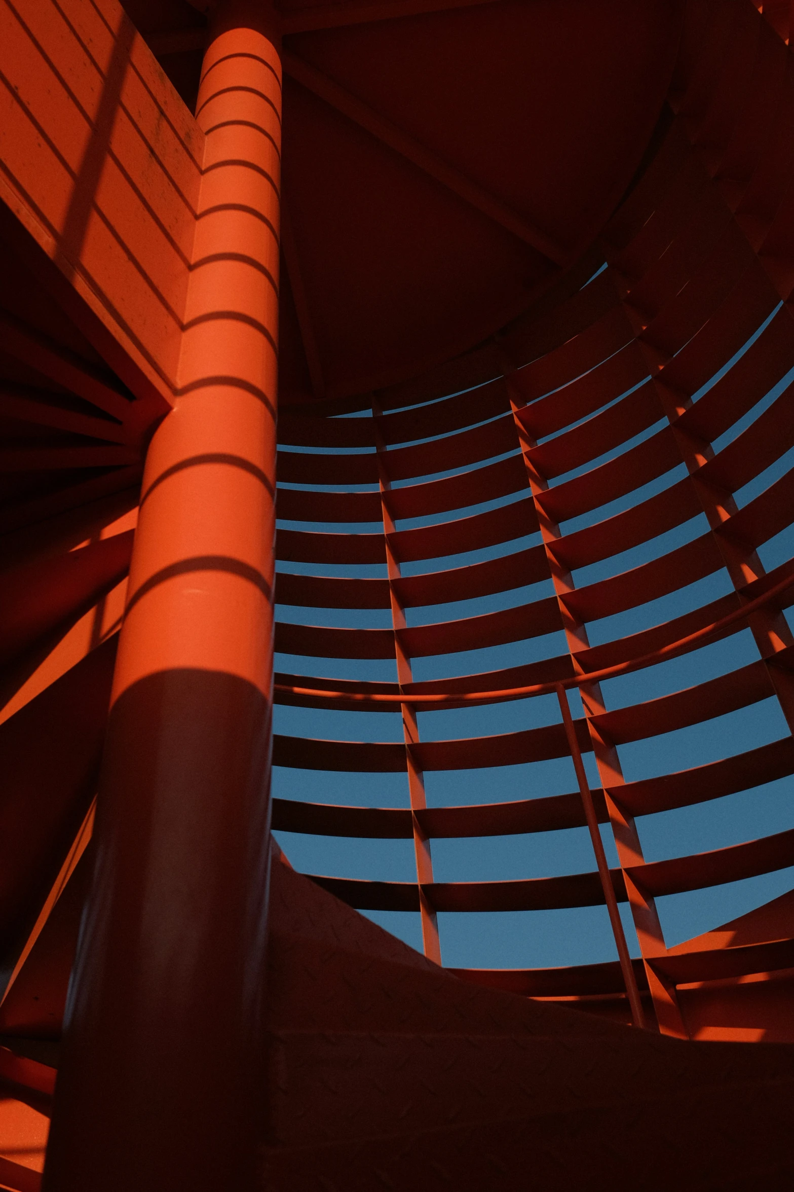 a curved red ceiling with many different windows