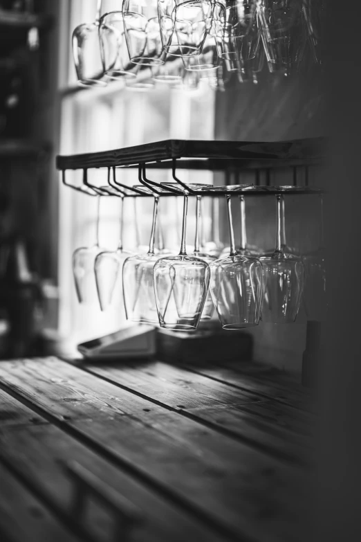 empty wine glasses in the sun shine brightly on a shelf