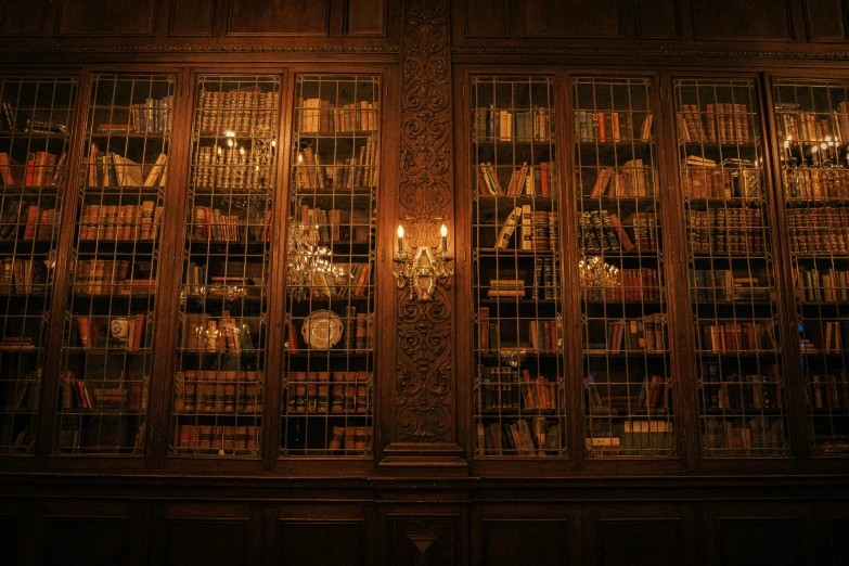 an old book shelf with many books and candles