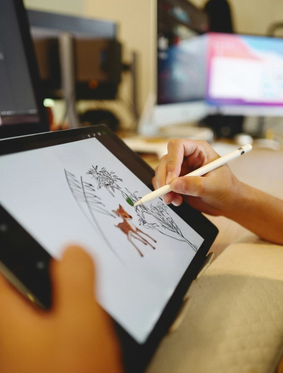 a woman is writing on a tablet with a pencil