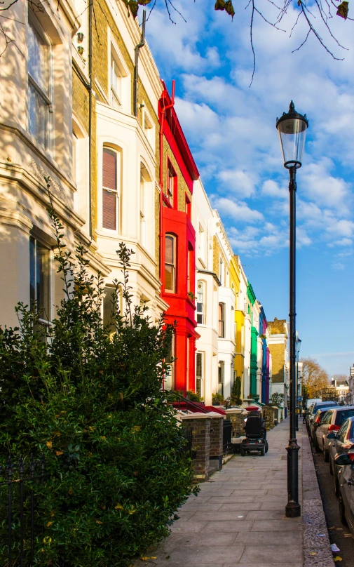 several different colored buildings lined along a side walk