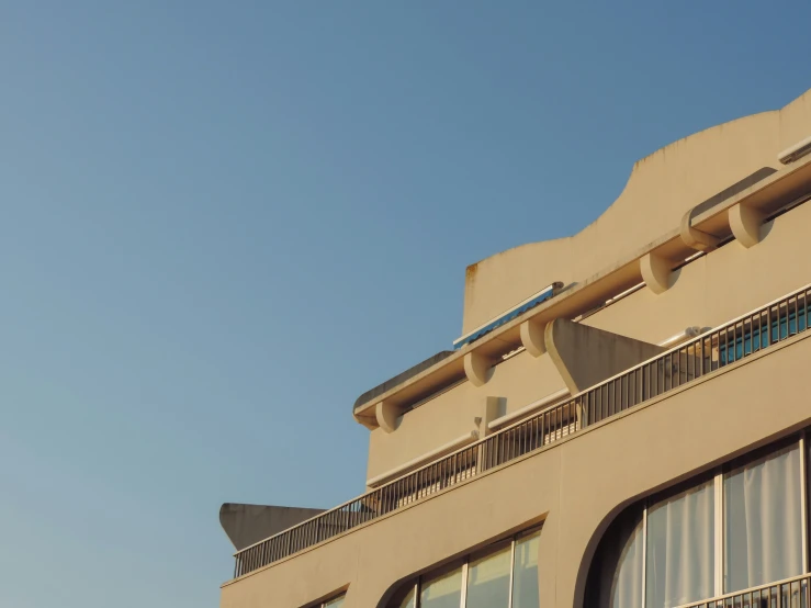 a building with a clock sitting on the corner of it