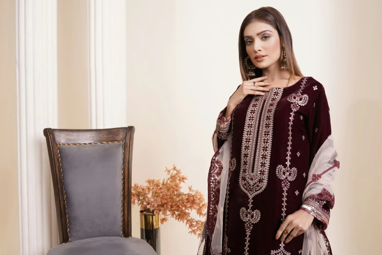 an indian woman in traditional dress in front of a chair