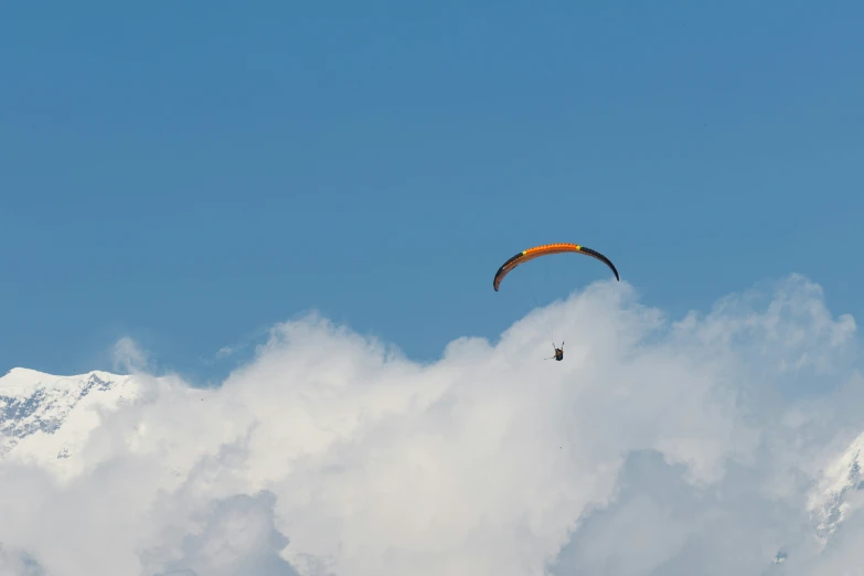 there is a paraglider going through the clouds