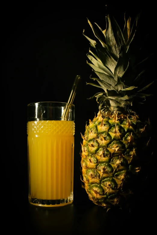 a glass of orange juice and a pineapple