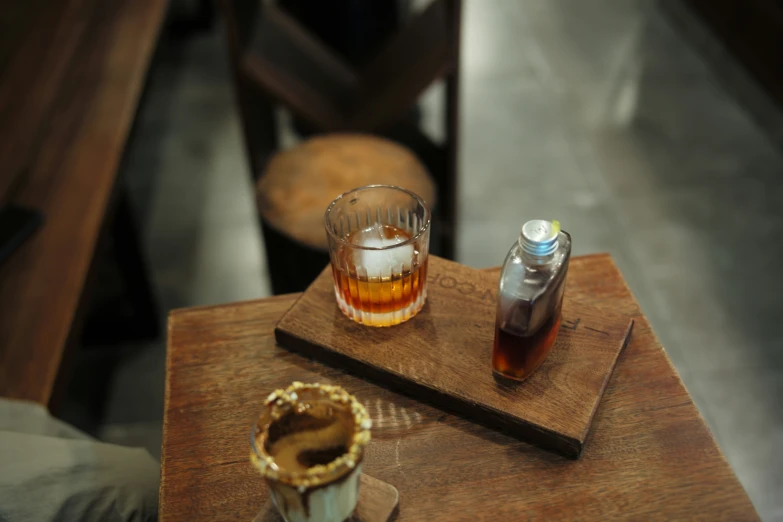 a wooden table with bottles of liquid on top of it