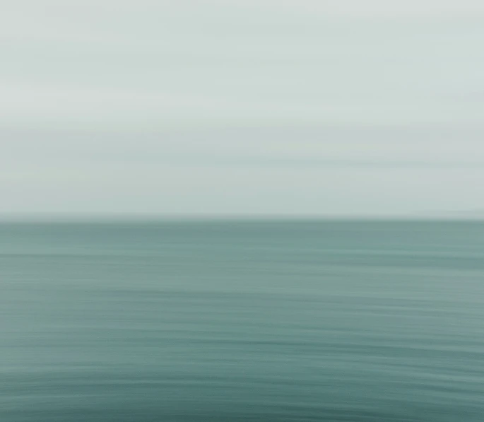 an ocean view of the sky with water in the foreground