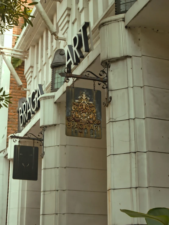 an entrance sign on a white building