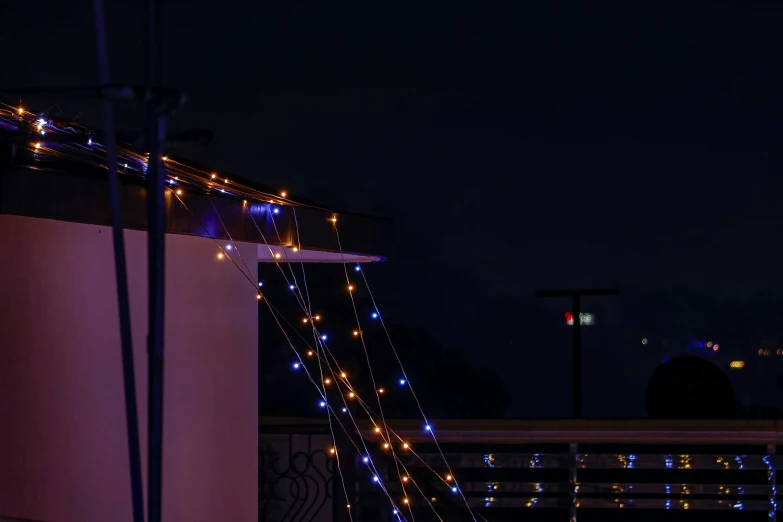 lights on an outdoor patio make it look like there is no roof or other furniture in this area