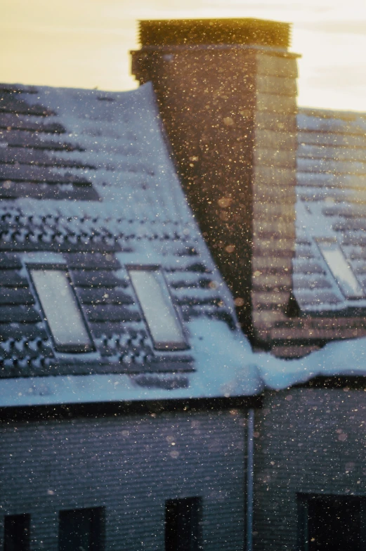 snow covers the roof of a house