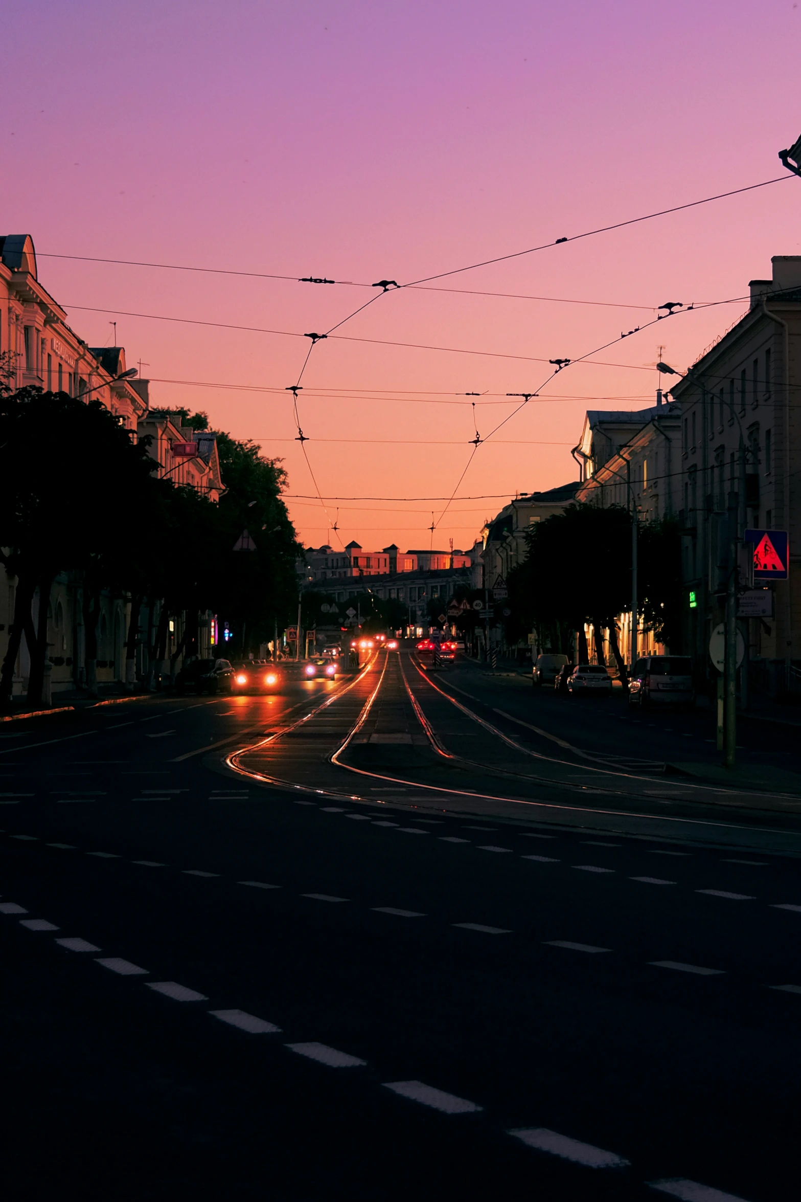 a city street with light traffic and wires