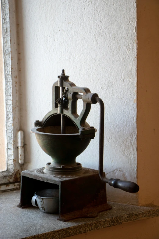 a coffee pot and a spoon are on the counter