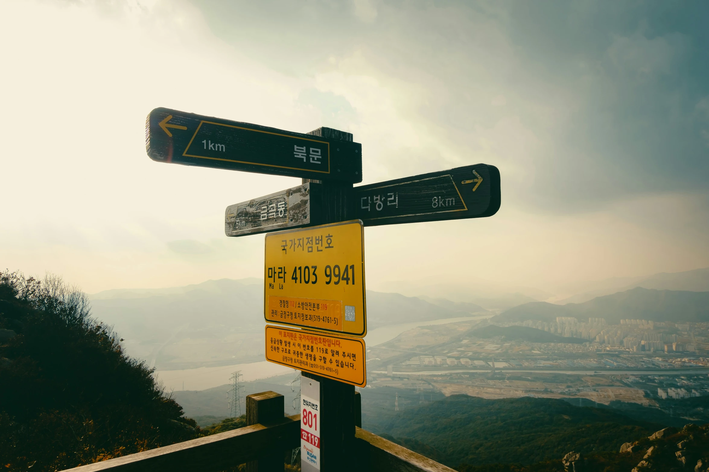 this is an image of many signs on the edge of a mountain